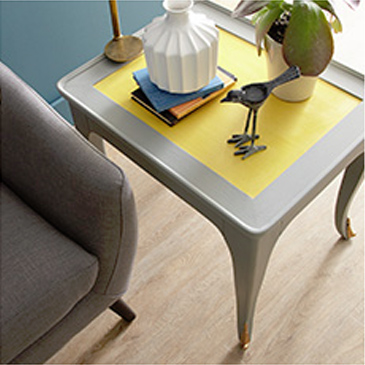 Dark grey chair next to grey and yellow table