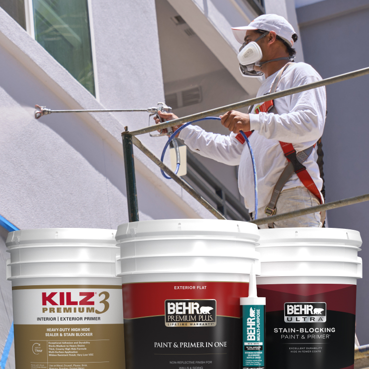 Behr rep talking with painter, 5 gal cans of Behr and Kilz paint