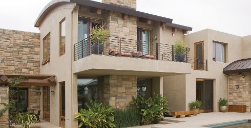 Neutral styled, southwestern themed house with light brown walls, and dark brown trim.