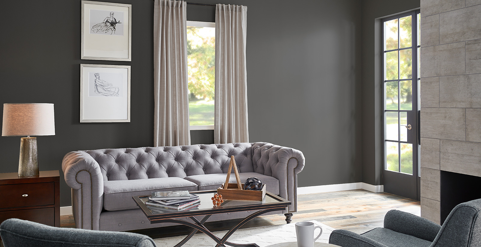 Minimal styled living room with dark gray on walls, white on trim, and light gray tufted couch