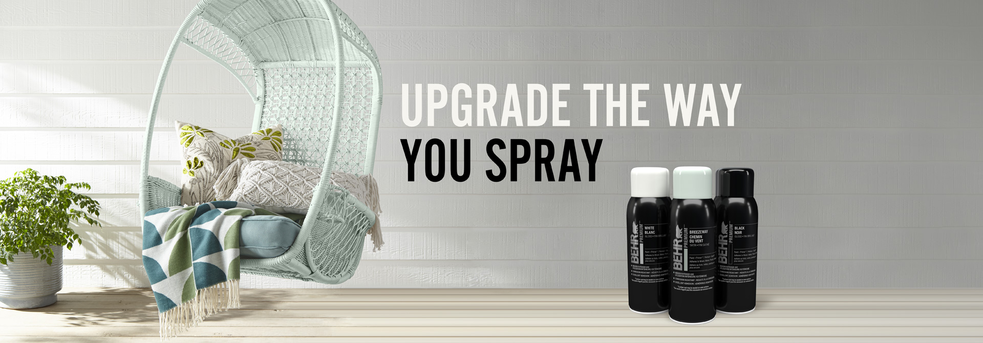 Behr Premium Spray paint cans with a chair in the background and text overlay that says Upgrade the way you spray.