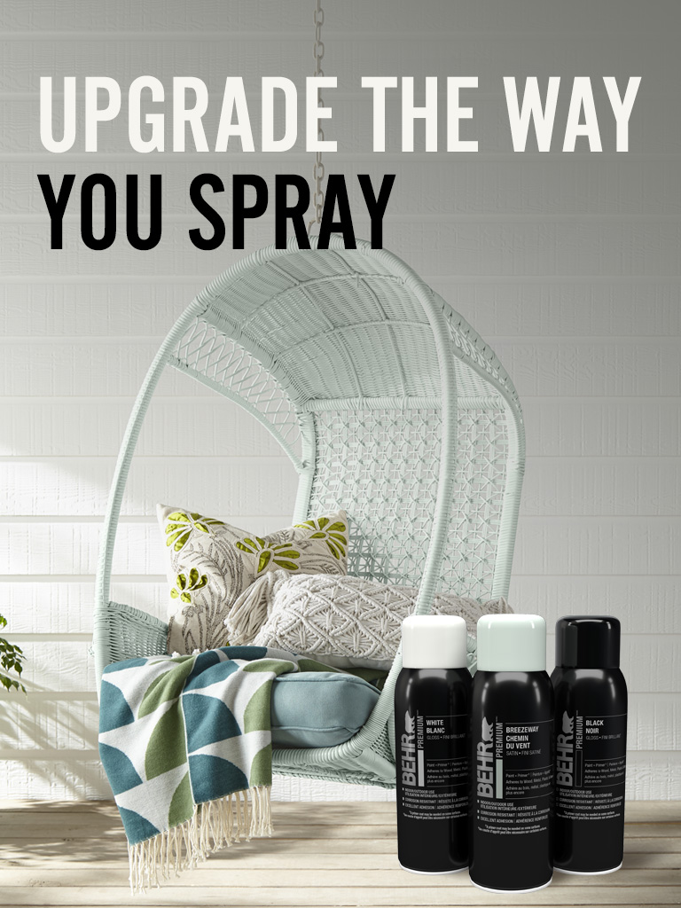 Mobile-sized image of Behr Premium Spray paint cans with a chair in the background and text overlay that says Upgrade the way you spray.