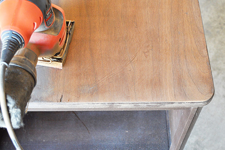 side table being sanded