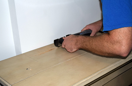 Cutting a notch in the top of the new wooden mantle