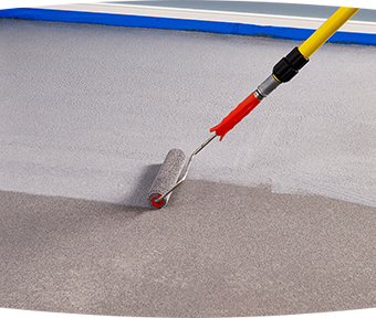 Applying granite grip to floor with roller