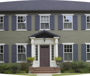 Front side of a home with many windows and big brown front door