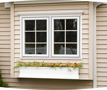 House with windows and flowers hanging off house below window