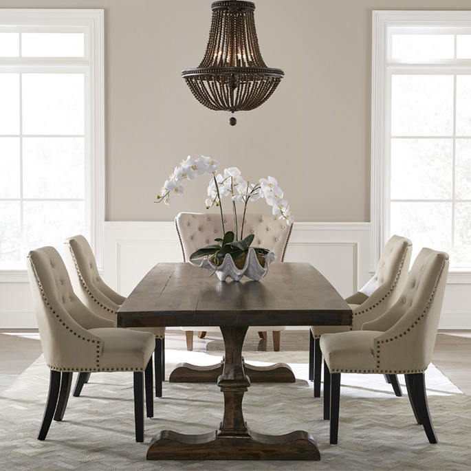 A tan and white dining room painted with Behr Dynasty Interior paint