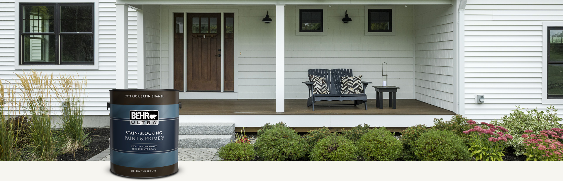 White house exterior with a can of Behr Ultra Exterior Satin Enamel in foreground