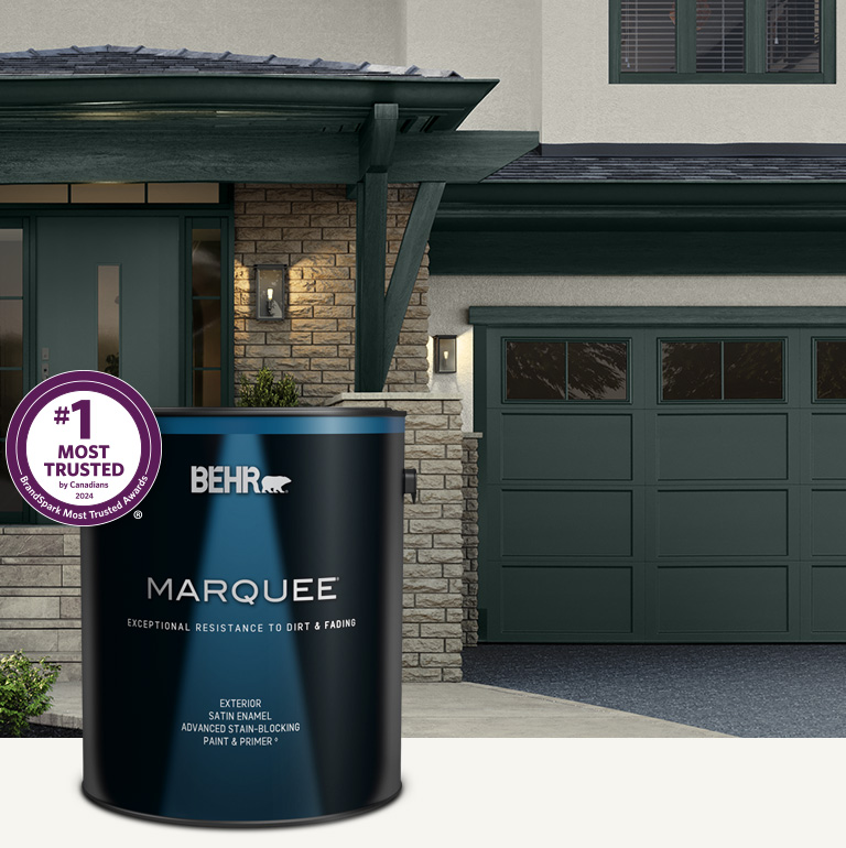 Mobile version of a white house exterior with a can of Behr Marquee Exterior Satin in foreground