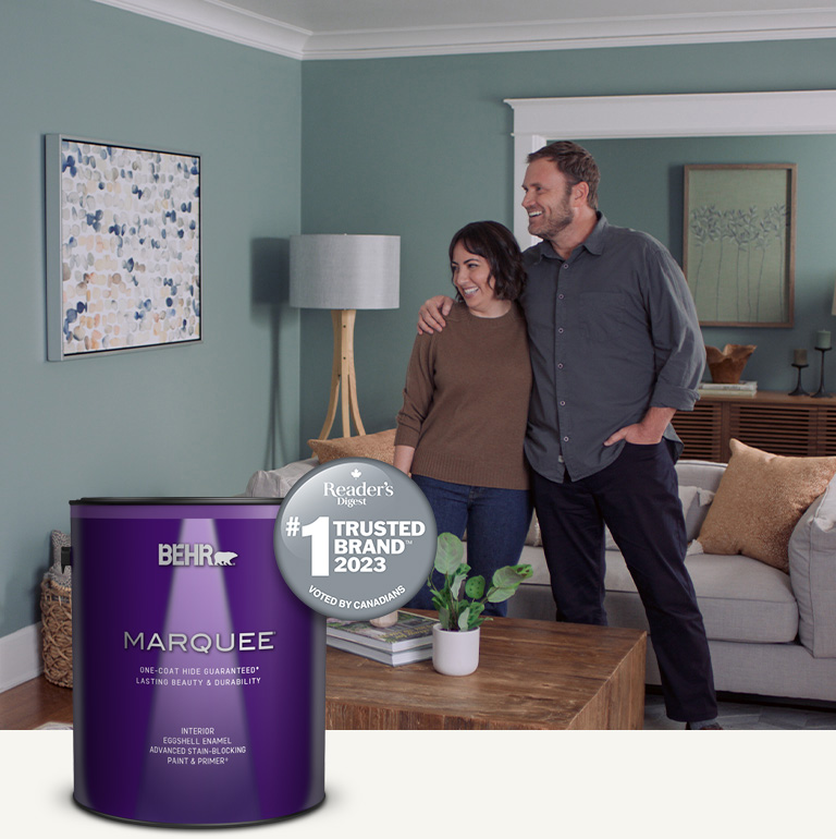 Mobile version of a living room painted in Marquee interior paint with a smiling couple in the background
