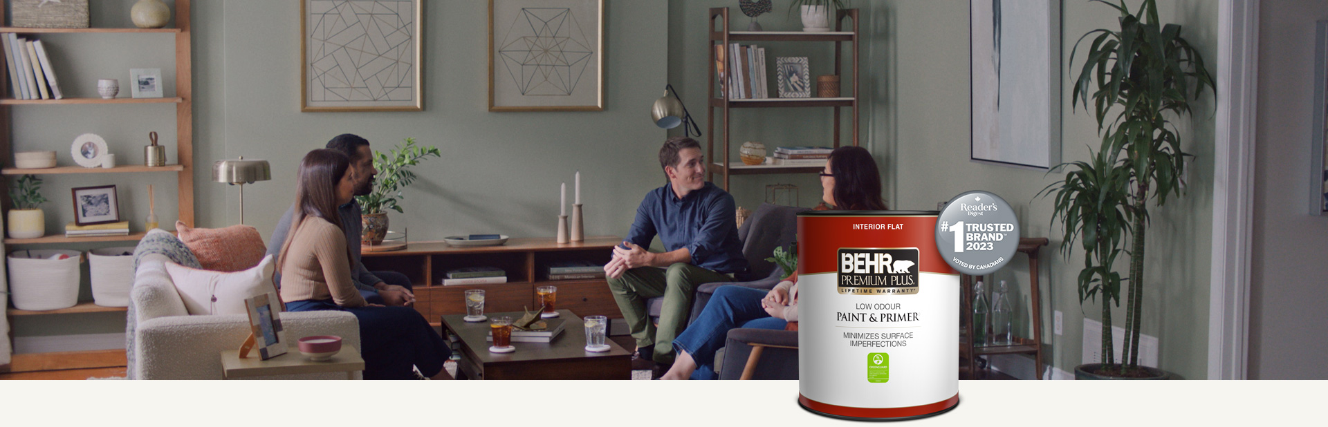 Family sitting in a painted living room with a Behr Premium Plus Interior Flat Paint