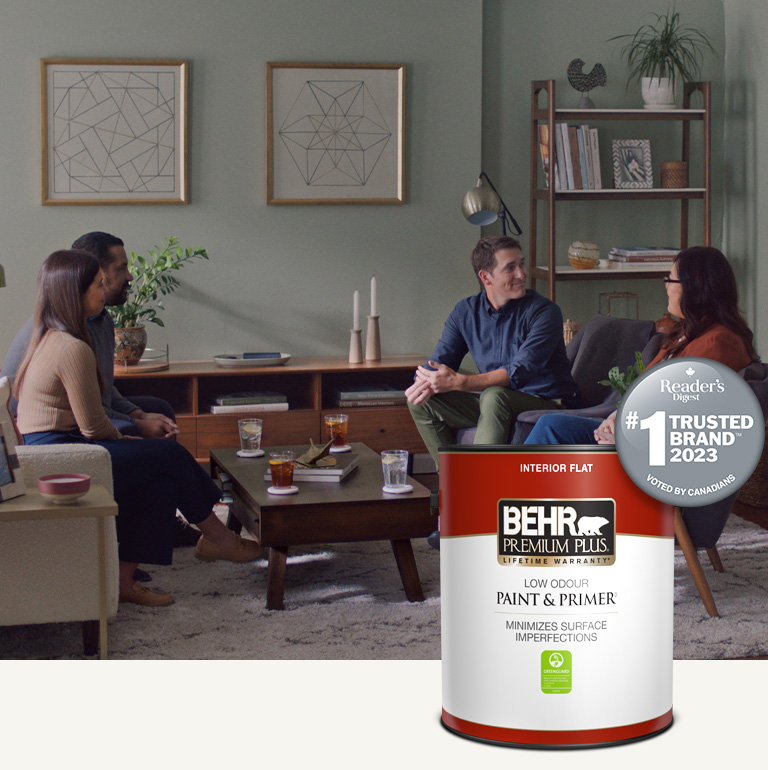 Mobile version of a family sitting in a painted living room with a Behr Premium Plus Interior Flat Paint