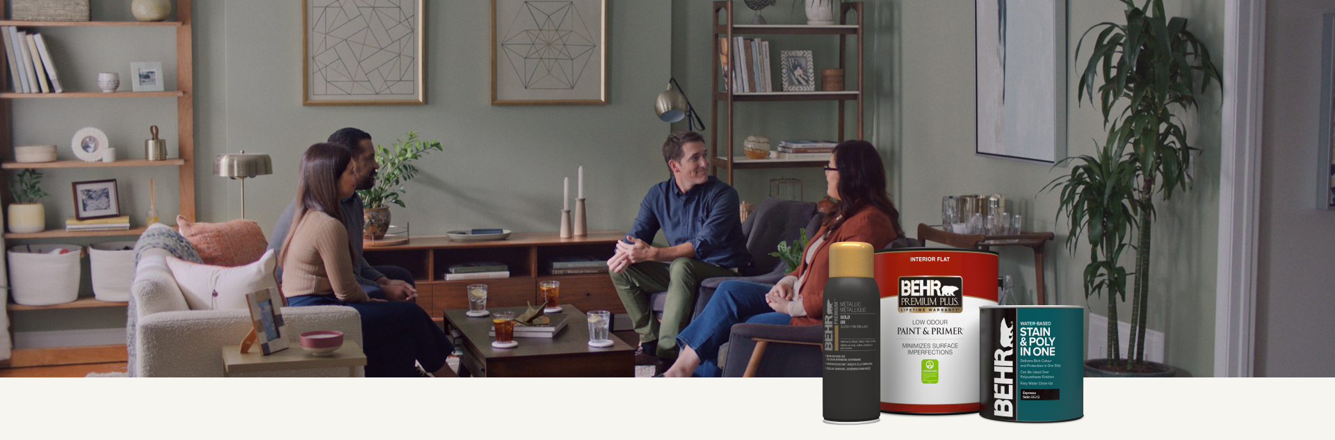 Two couples sitting in a painted living room with a cluster of Behr paint, spray paint, and interior stain