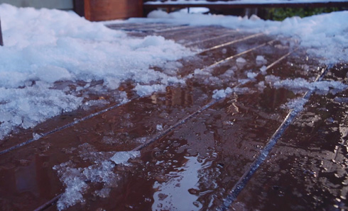 Deck with snow melting on it