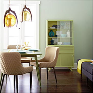 Dining area with a table, 3 chairs, and light fixtures hanging above