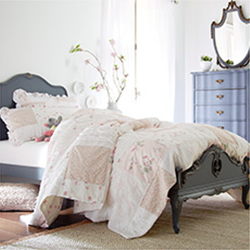 Grey bed with white comforter and matching dresser