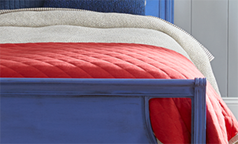 Bed with blue frame and red comforter