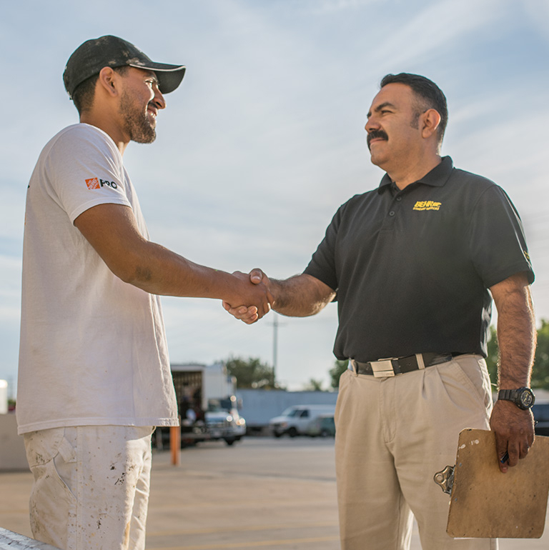 A Behr Pro Rep shaking hands with a Pro Contractor