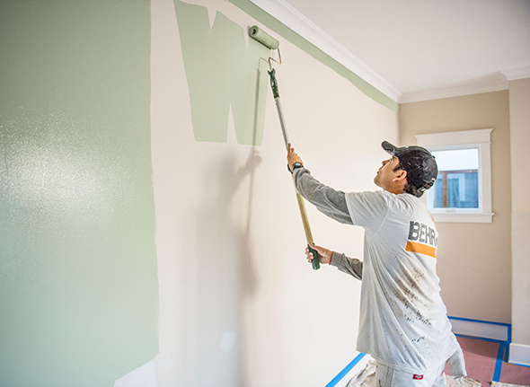 Painter rolling wall
