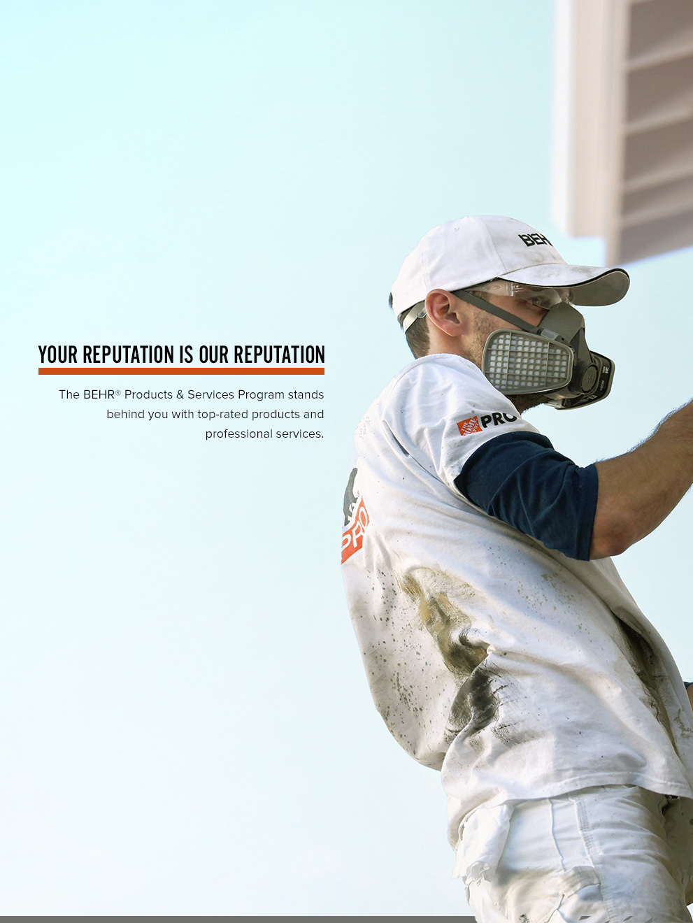 Mobile view of an Image of a Pro Contractor wearing a hat and shirt with Behr logo spray painting an exterior wall of a house on a ladder.