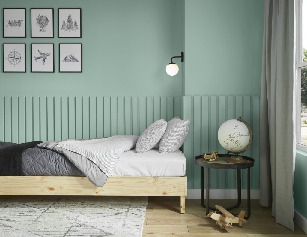 The bedroom, showing a section of it with the wood slats on the wall behind the bed.