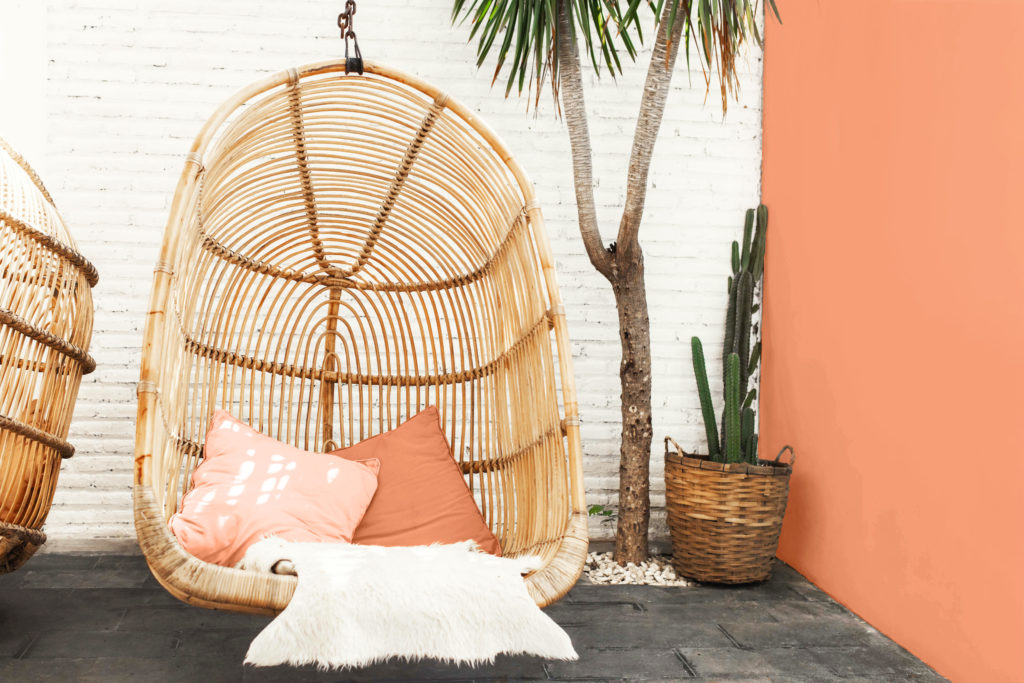 Outdoor seating area with chair and accent wall in Burning Coals.