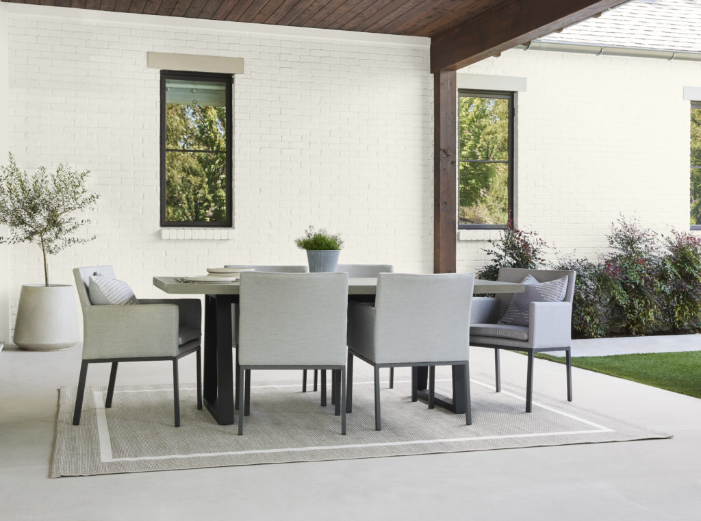 A covered patio and white brick wall make a great background for an outdoor dining area.  Blank Canvas is a light neutral that provides any living or dining design with a sleek and clean look. 