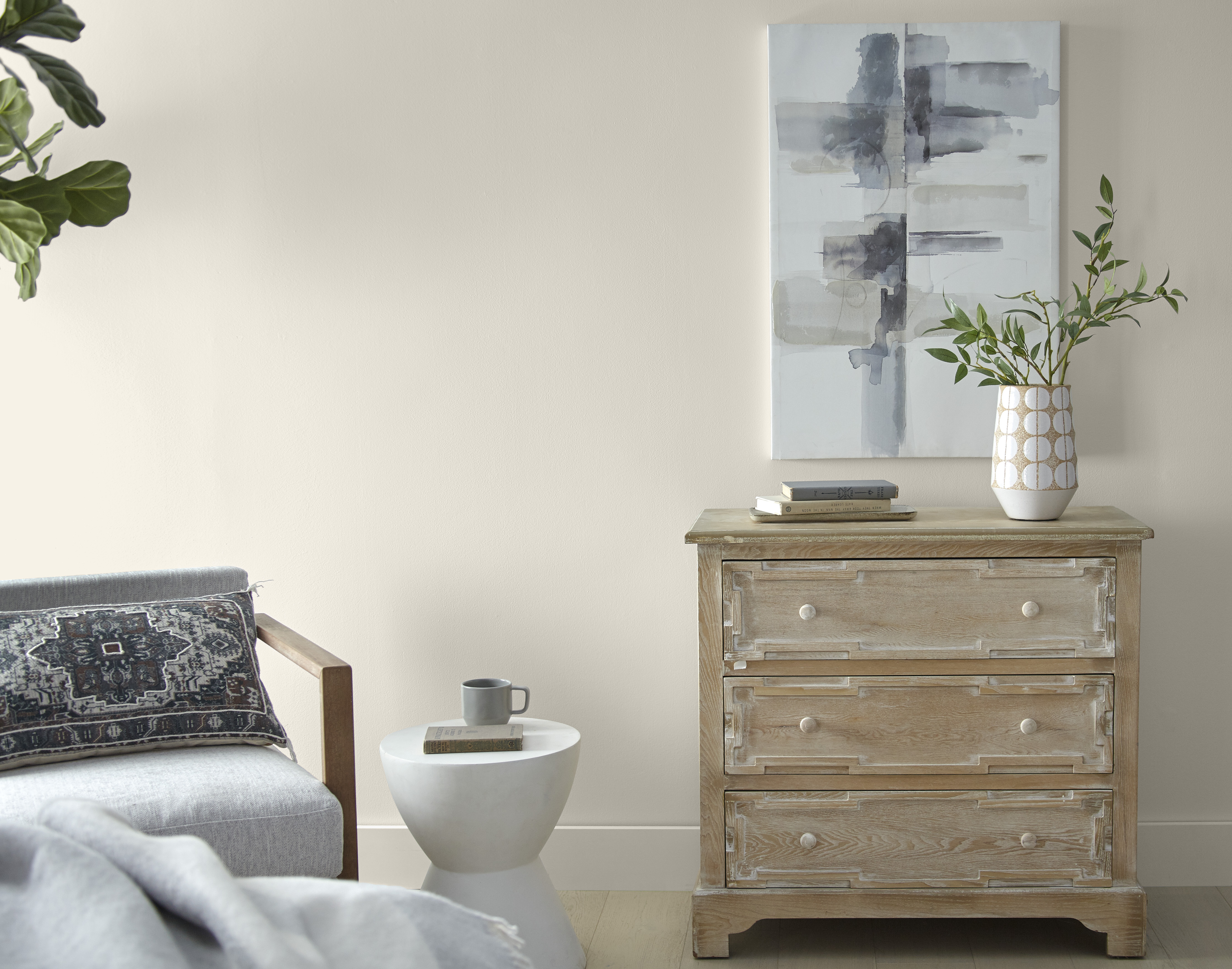 A simple and comfortable sitting room/reading area painted in a light, warm neutral colour called Tranquil Gray.