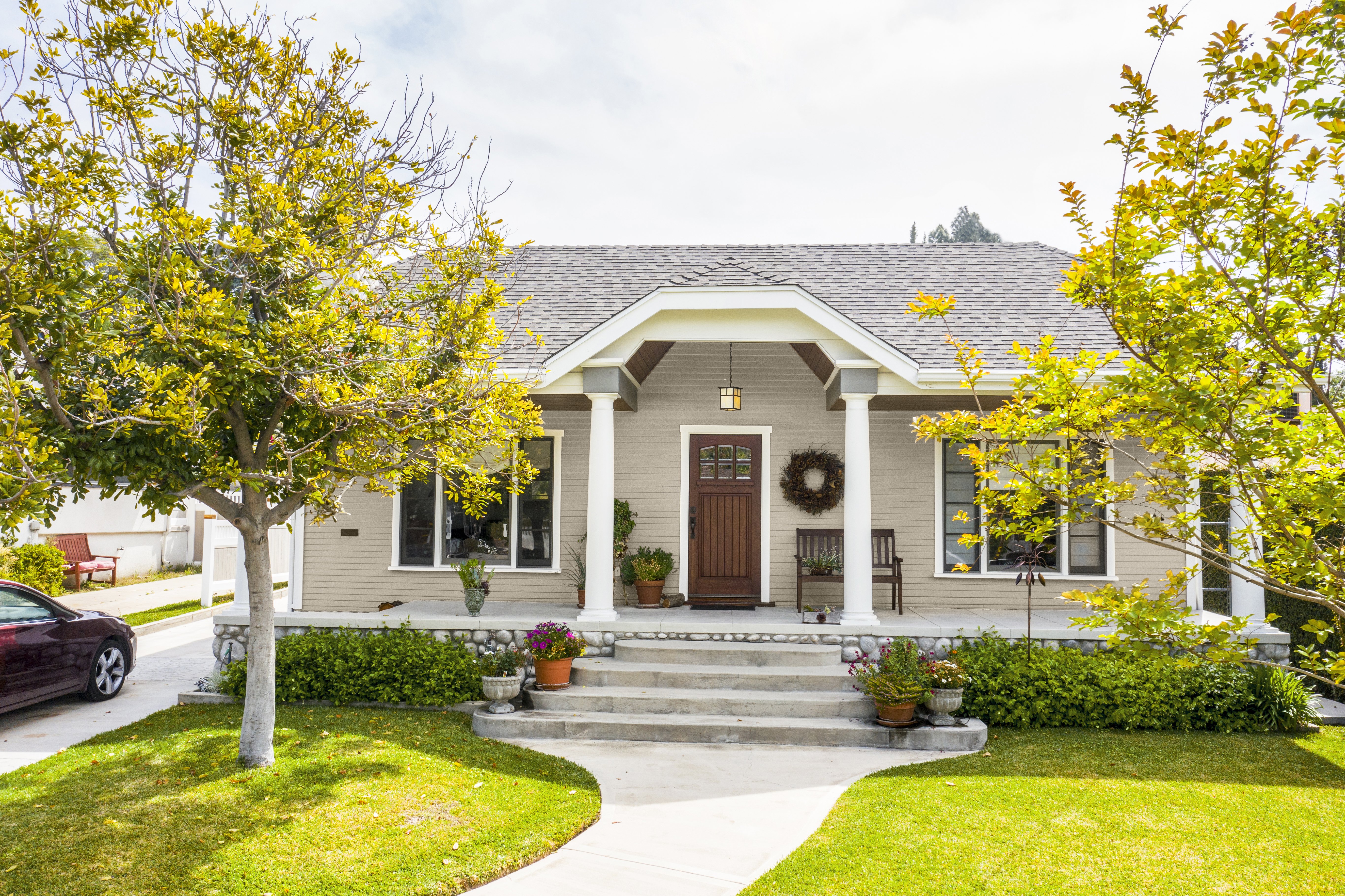 The exterior of a one-story house with siding painted in Even Better Beige.