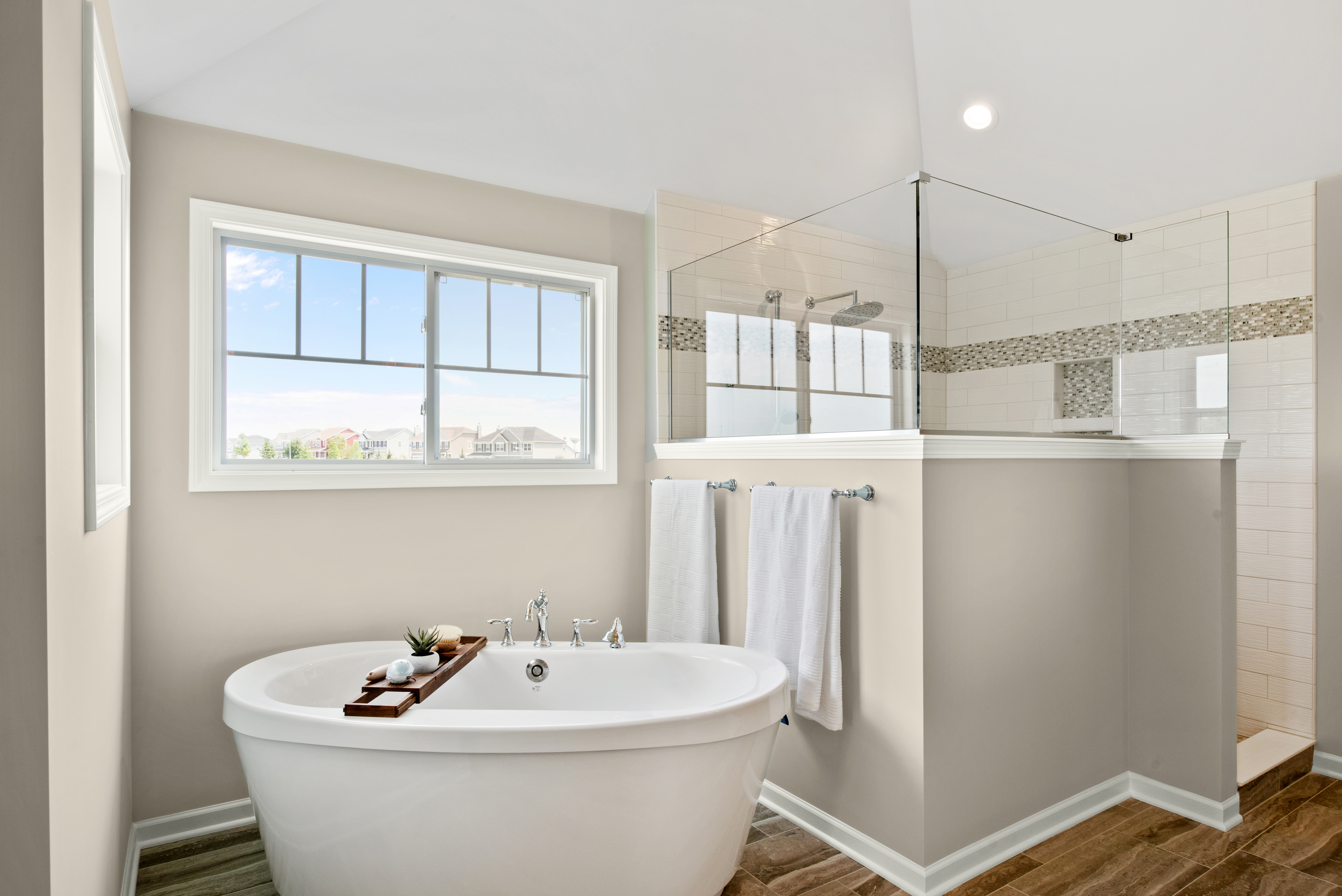 A large bathroom painted in Even Better Beige, with a walk-in shower and tub like a home spa.