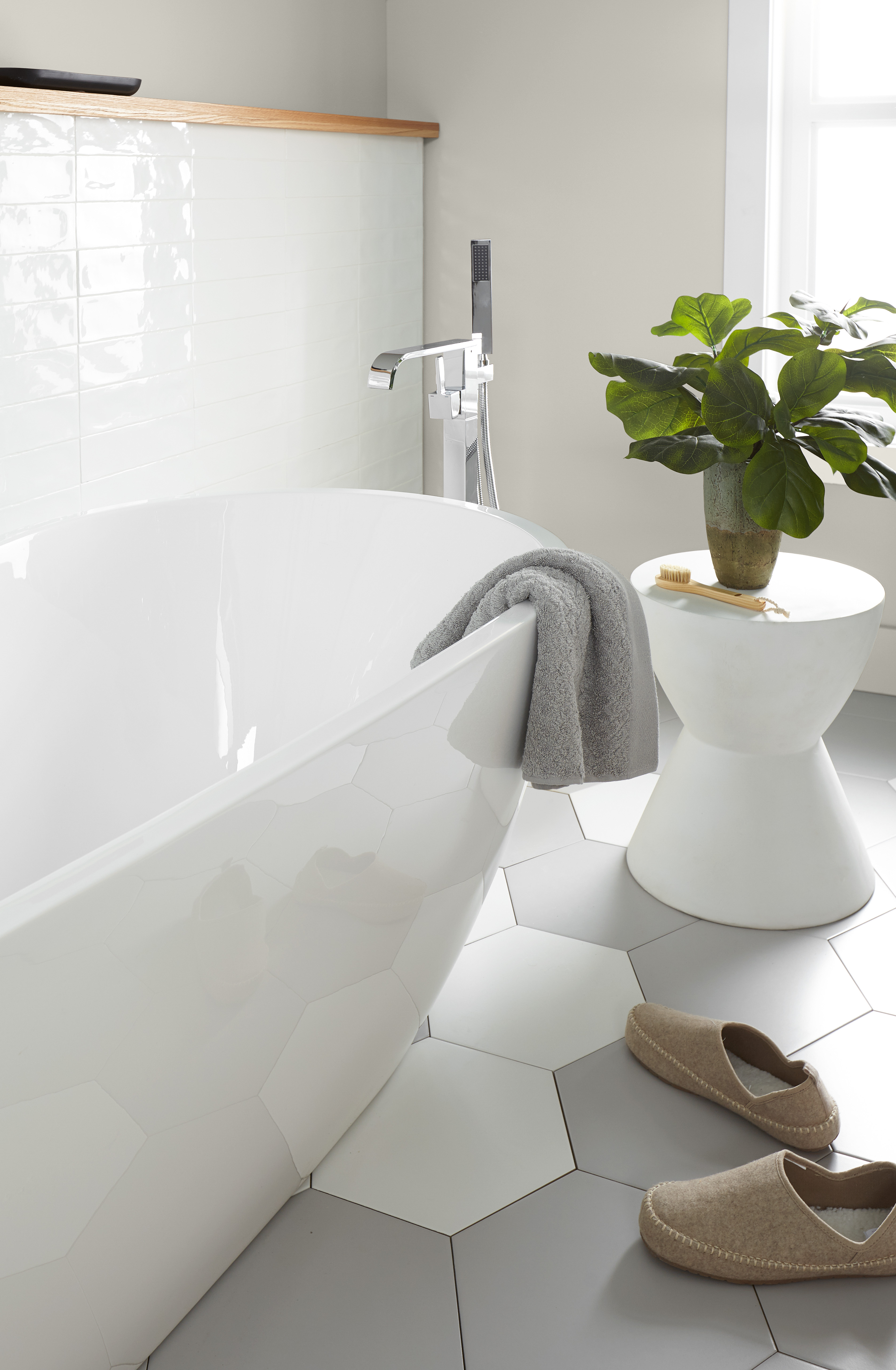 A spa-like bathroom with large white tub and walls painted in the colour Gratifying Gray.
