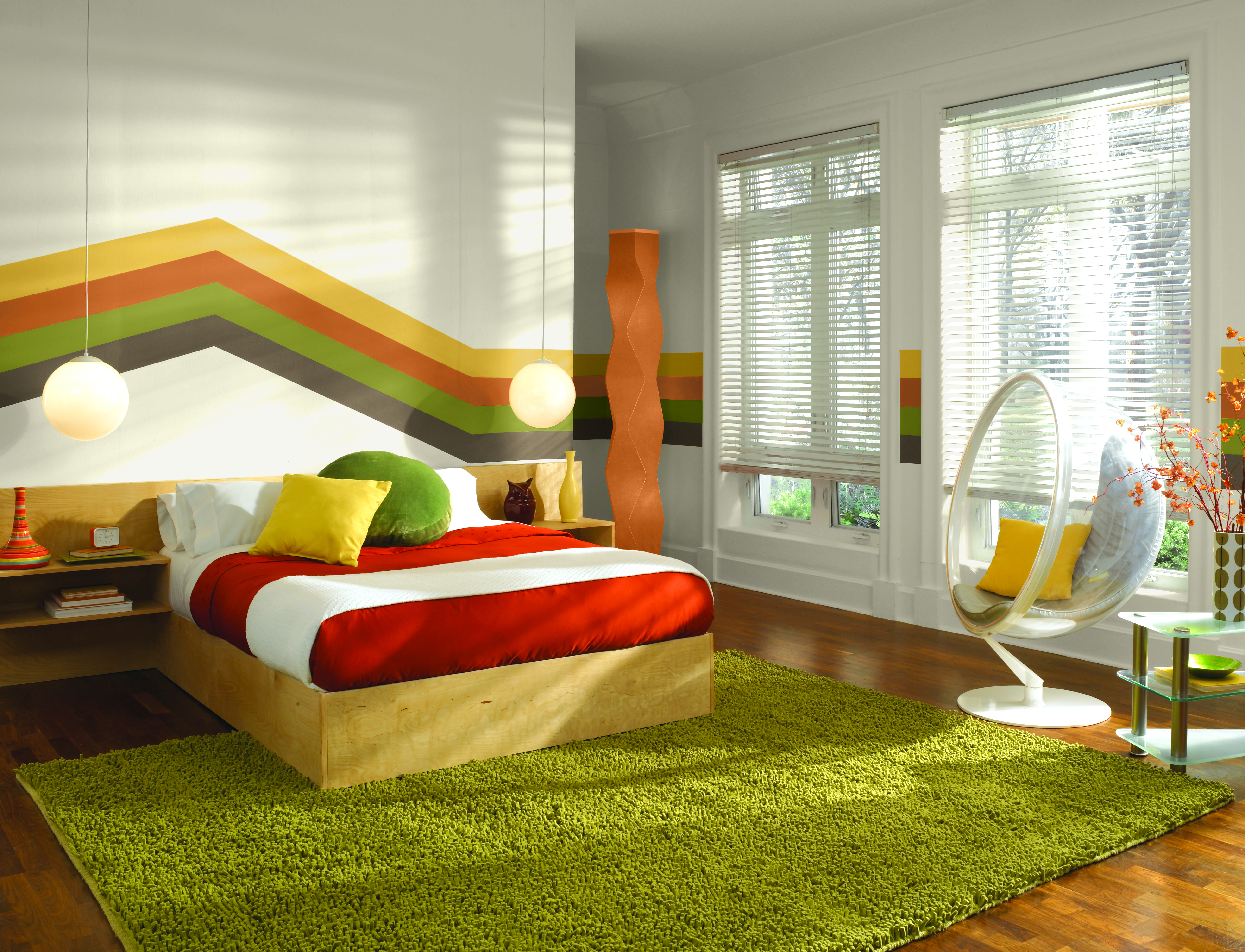 Retro-inspired bedroom with a colourful rainbow stripe design on the wall