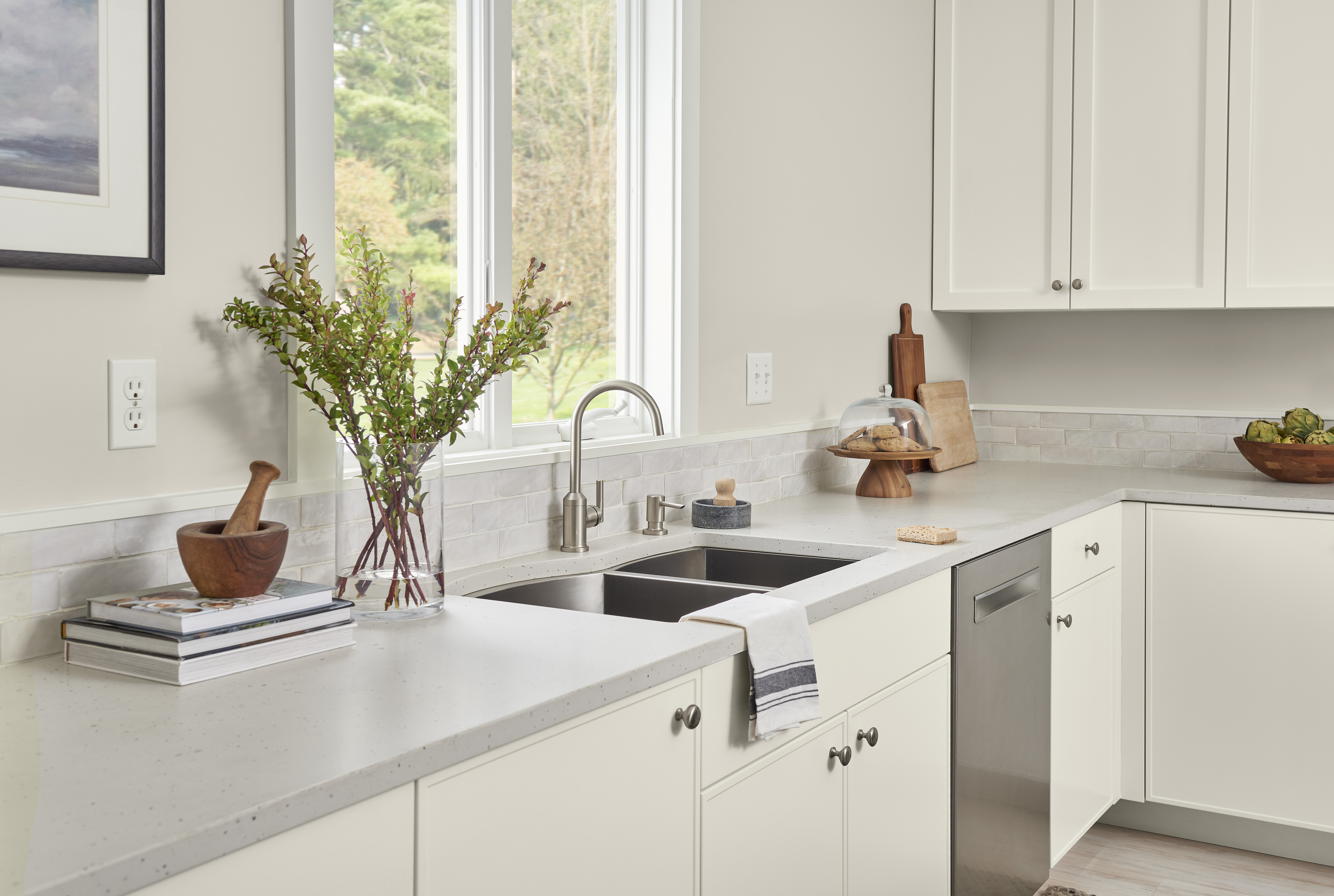 A bright and airy kitchen with walls painted in Tranquil Gray and trim in Natural White