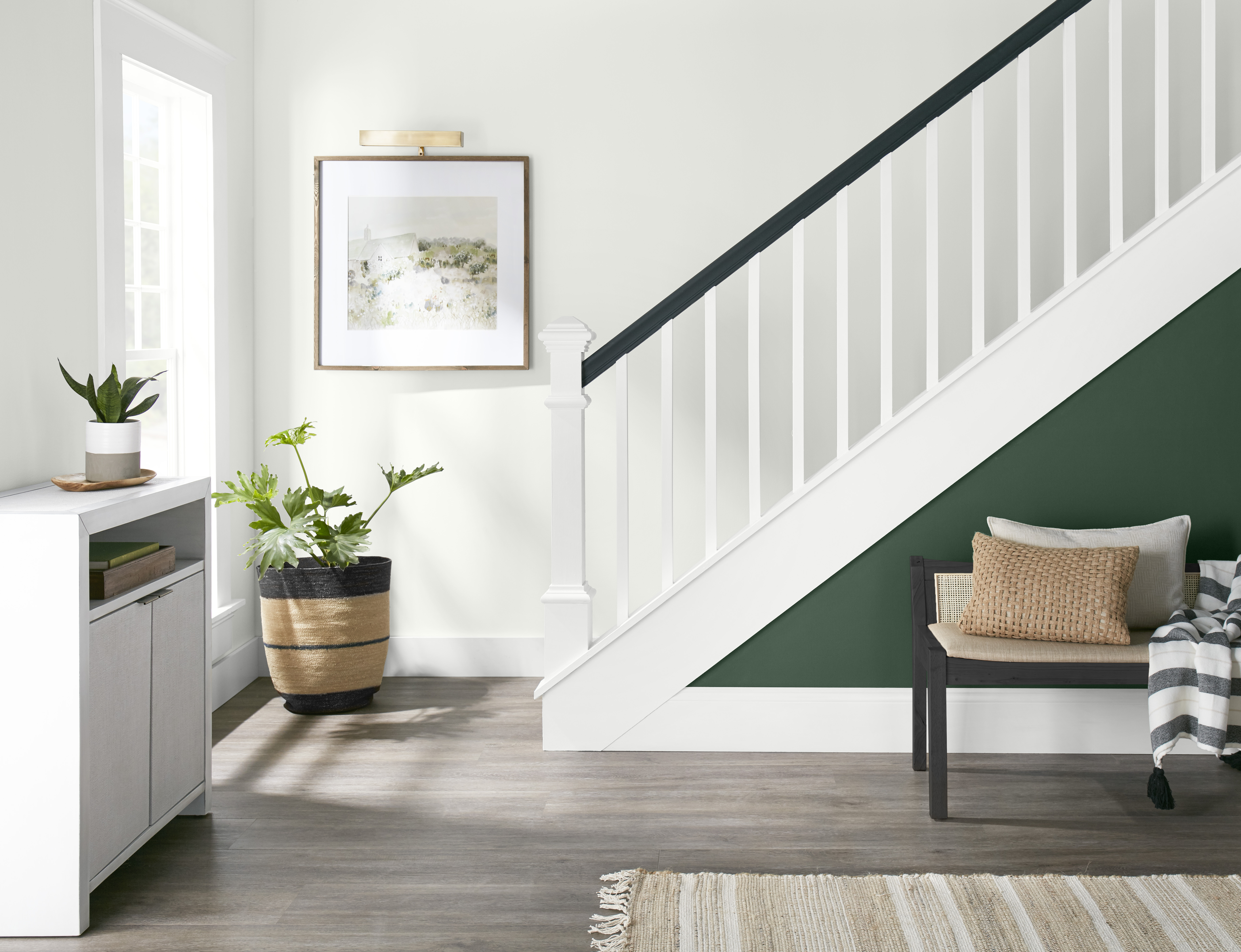 A bright and modern staircase with the side painted in a deep green colour.