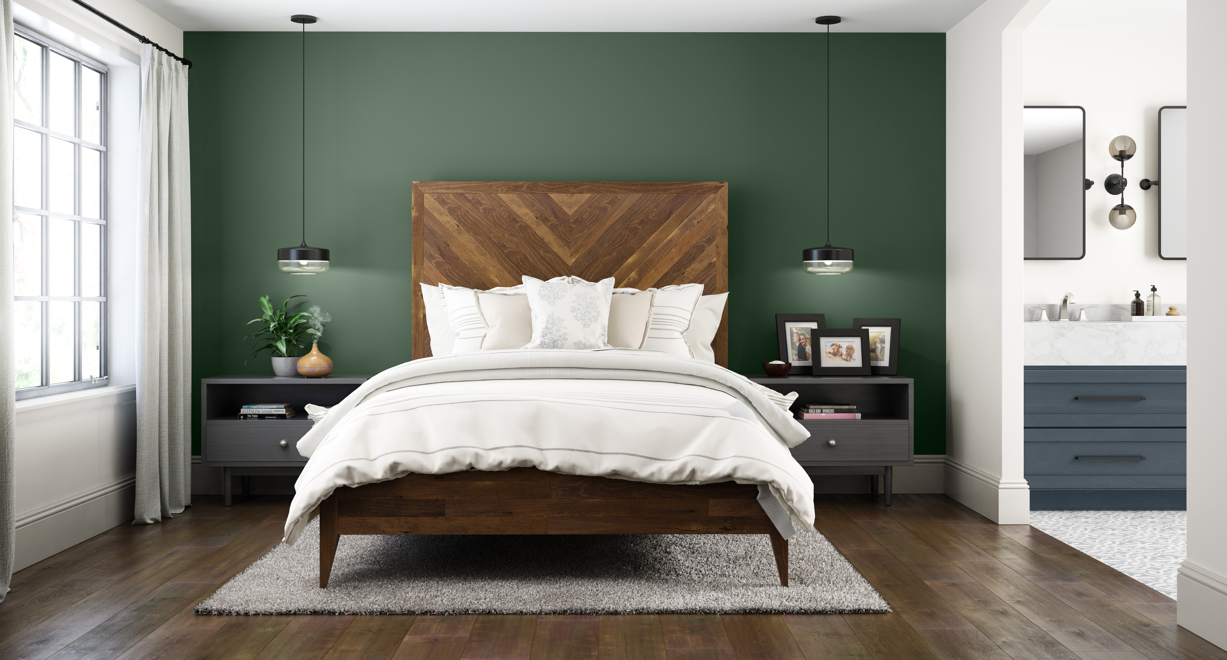 A white bedroom with an accent wall painted in a deep green colour.