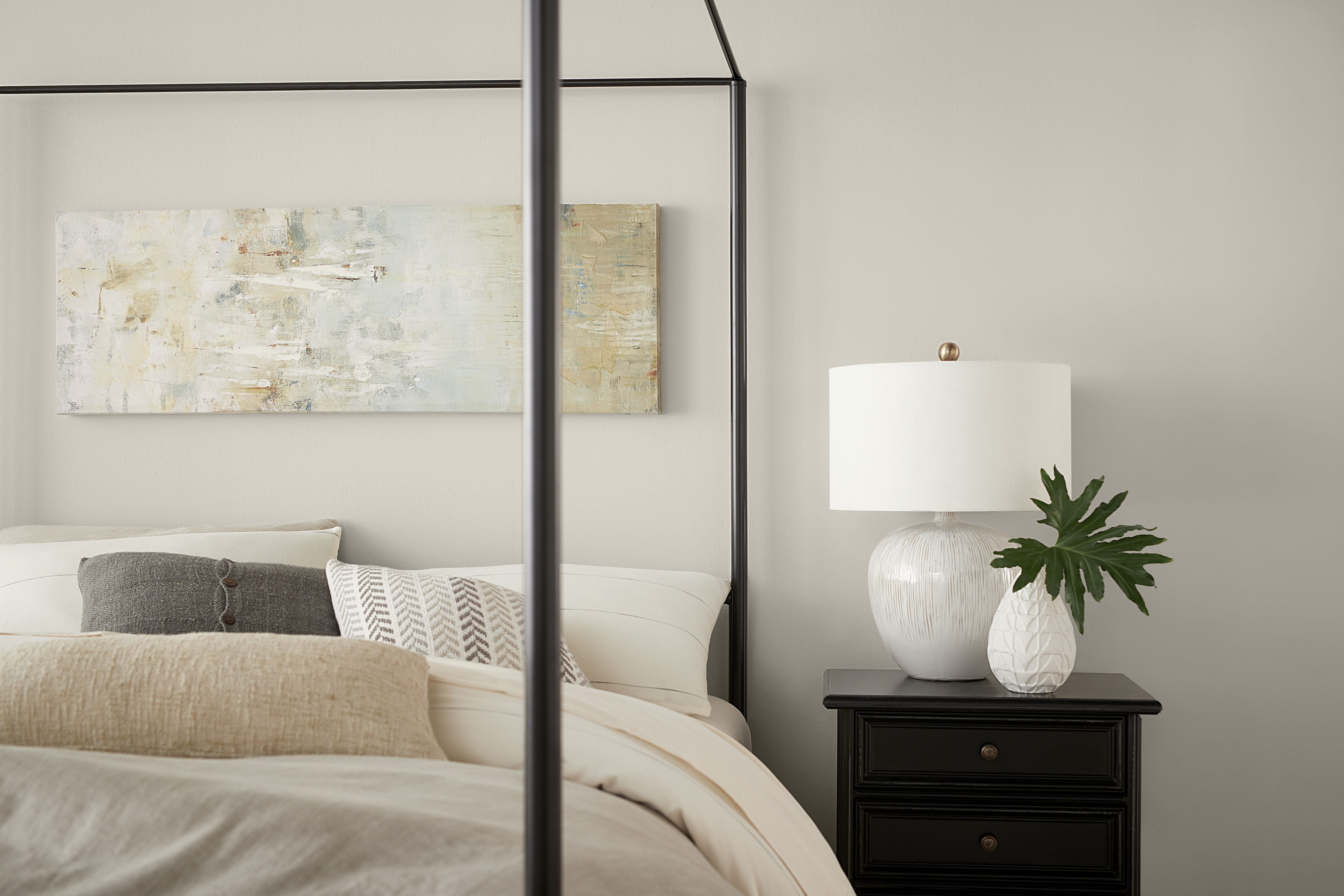 Closeup of a simple bedroom with walls painted in Tranquil Gray