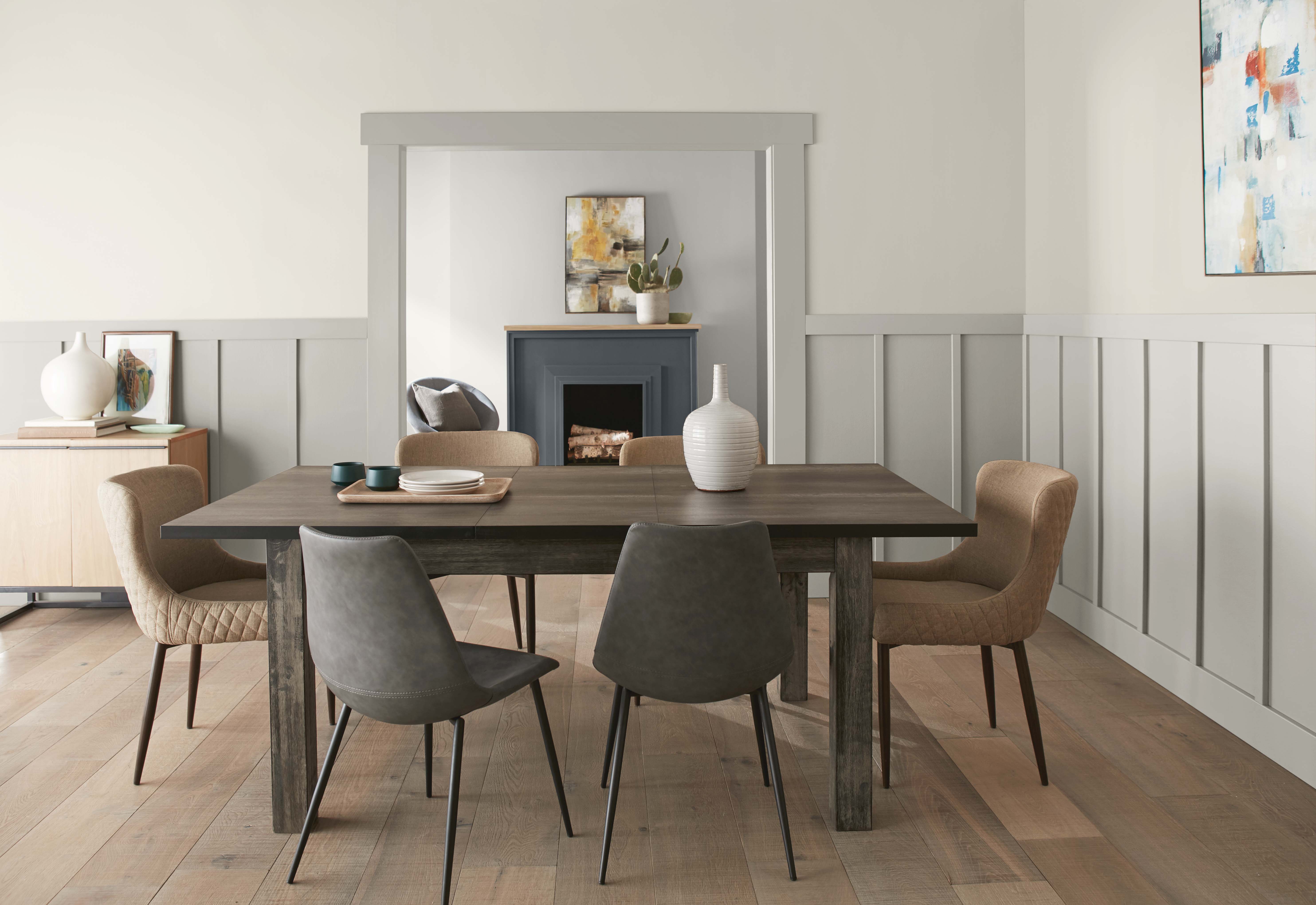 A neutral dining room with walls painted in Tranquil Gray and board and batten in Greige