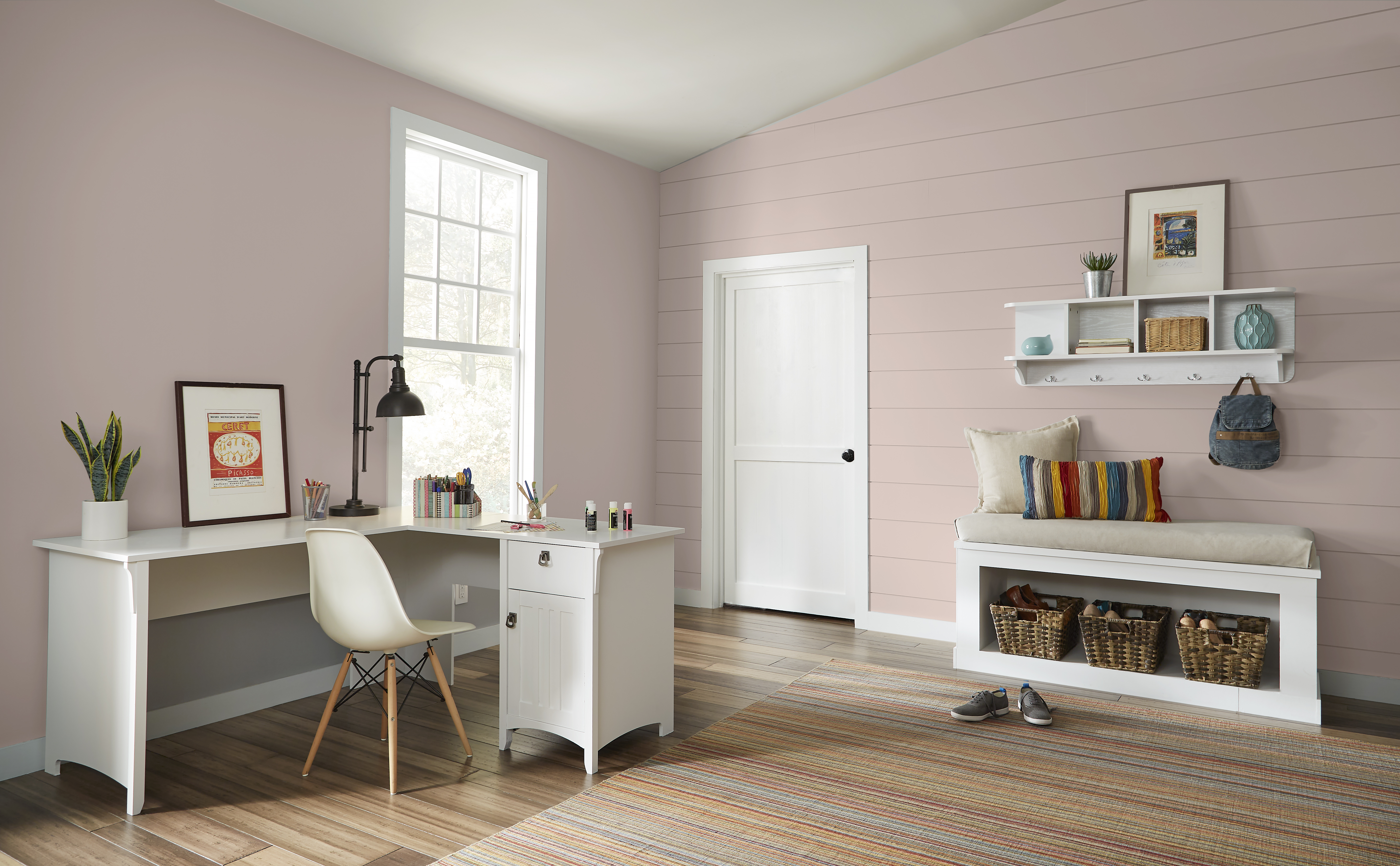 A large home office with walls painted in Smokey Pink and a desk in white