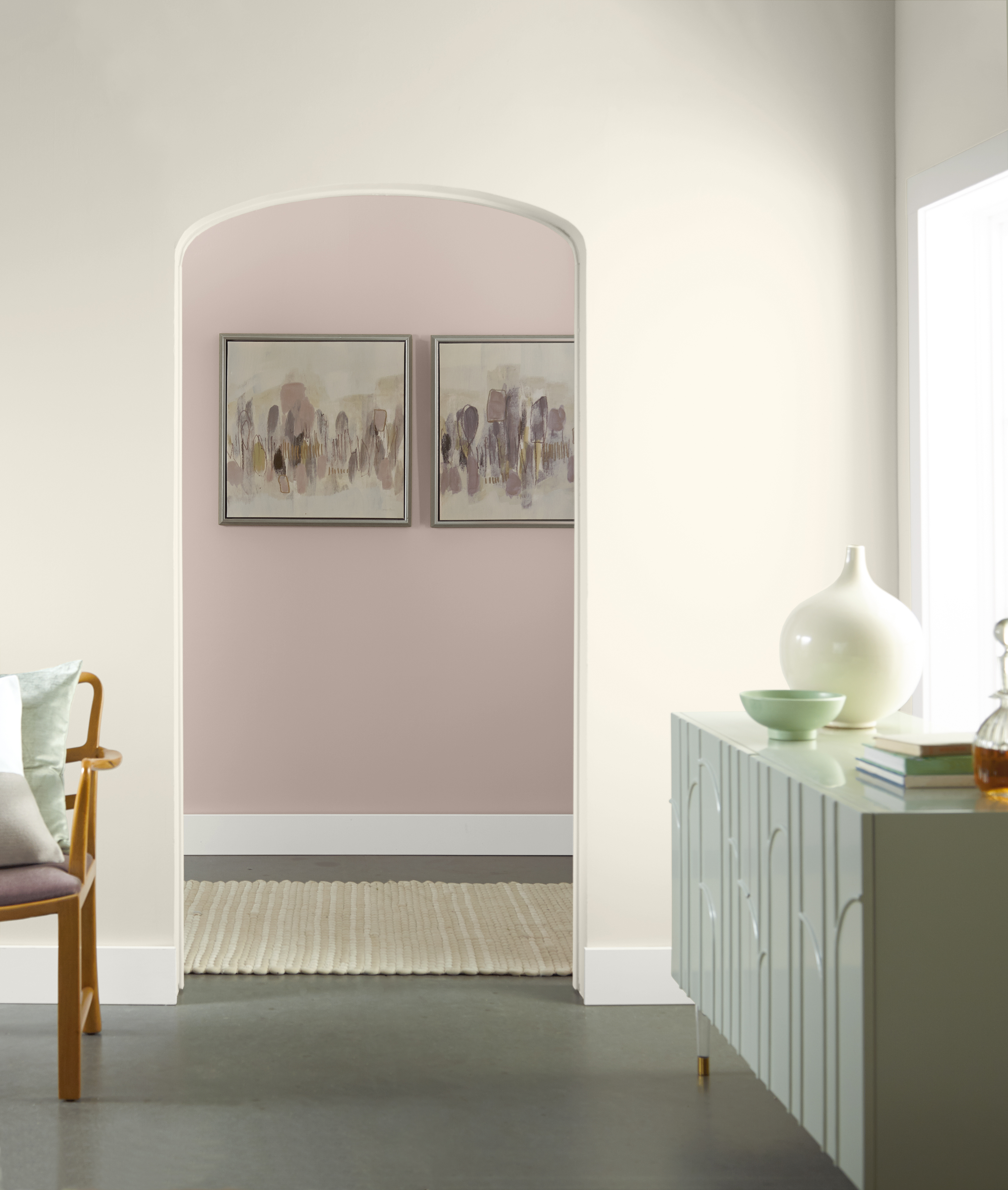 An archway with a view into an entry space painted in Smokey Pink