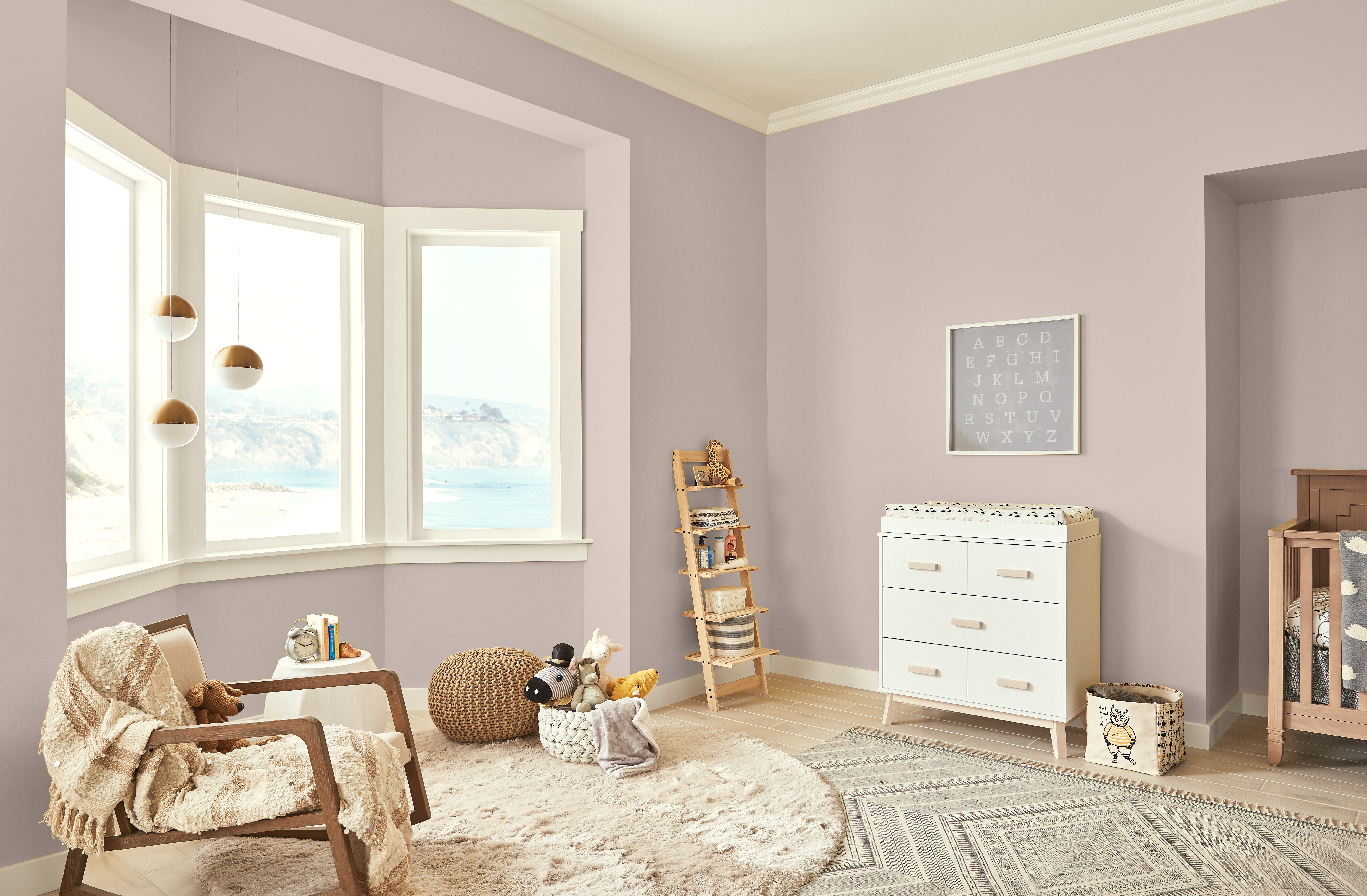 A spacious kid’s room/nursery with walls painted in Smokey Pink and large windows 