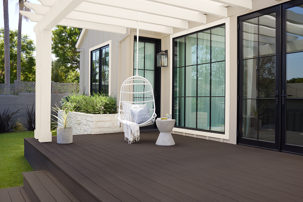 A backyard with a white swing and the deck in Cordovan Brown