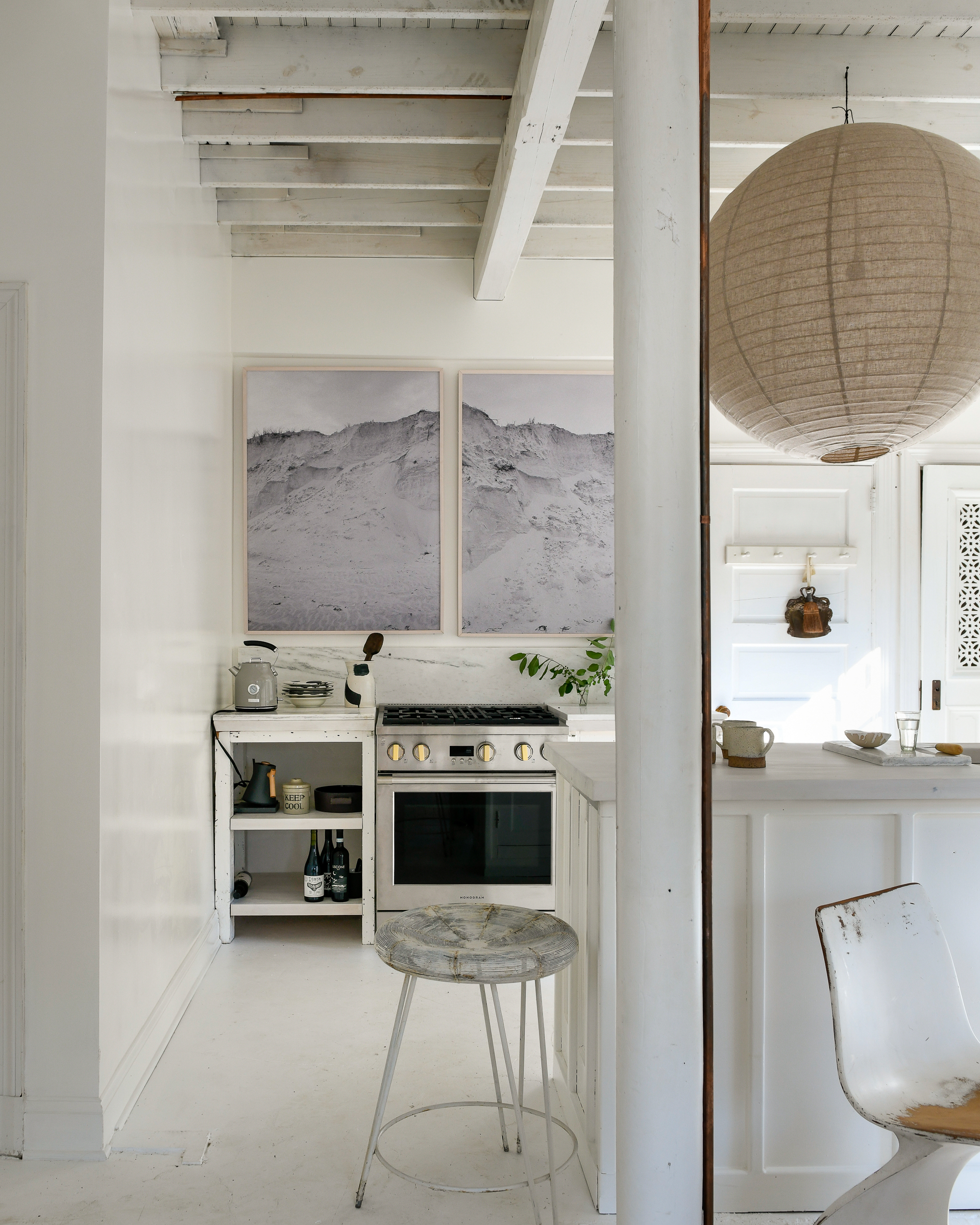 Leanne Ford’s bright and simple kitchen with walls painted in Natural White and styled with large grey-scaled artwork
