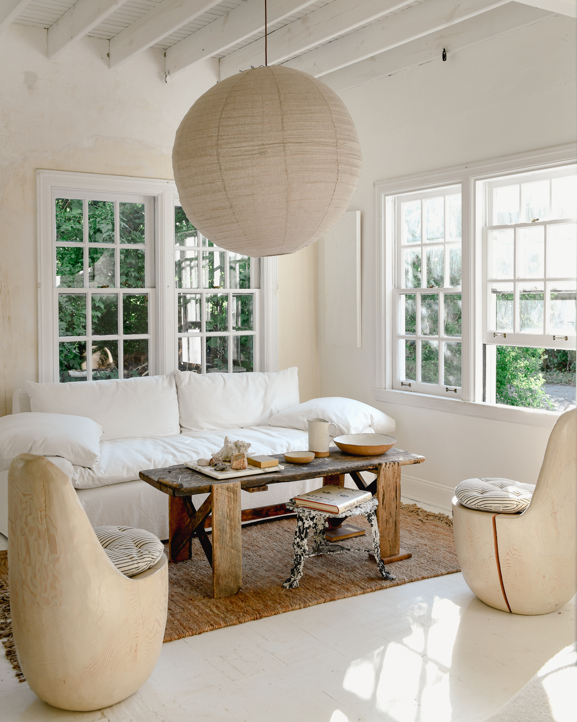 Leanne Ford’s living room with walls painted in Natural White and styled with furniture and accents in creamy whites and beige