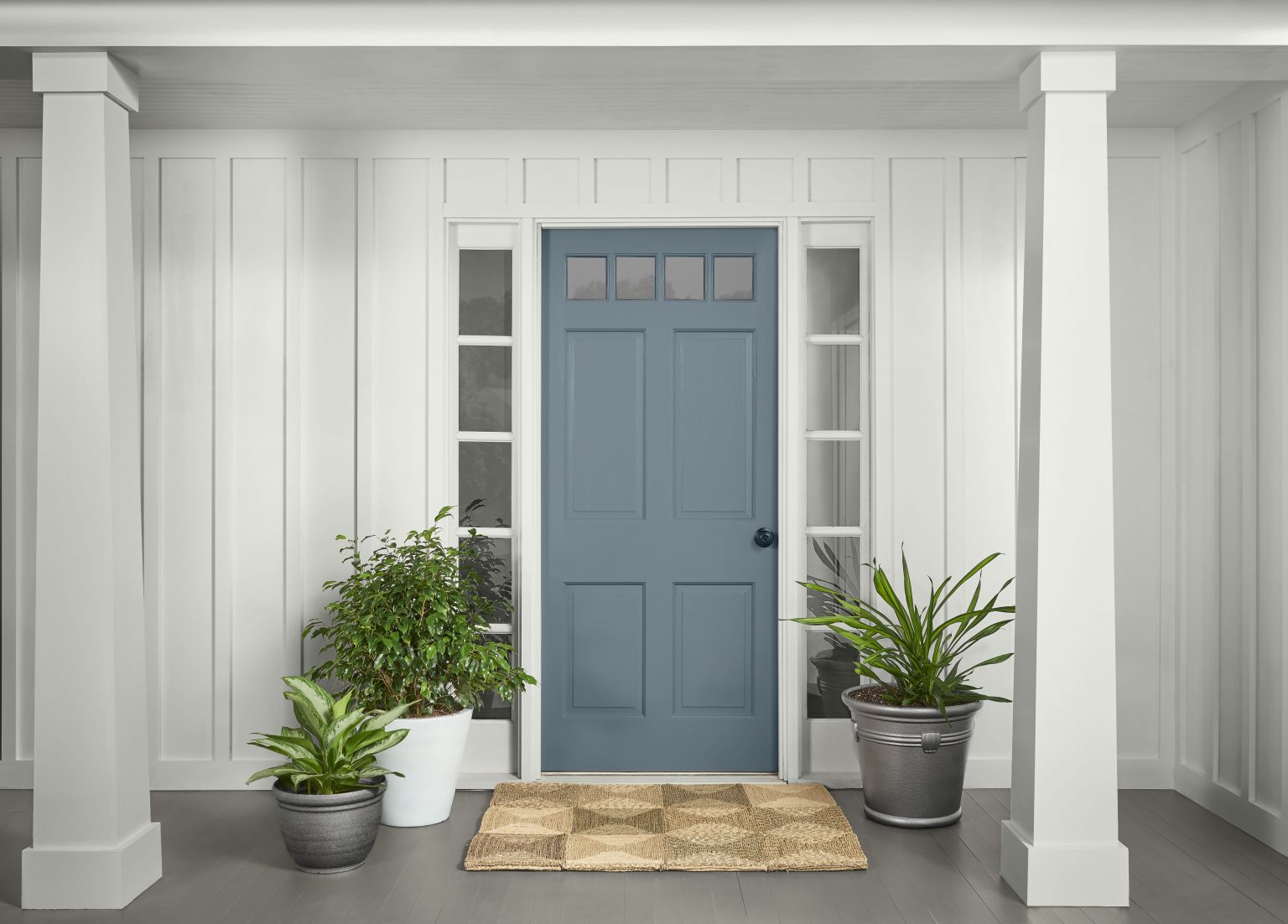 An exterior front door painted in Adirondack Blue, contrasting with the surrounding white walls