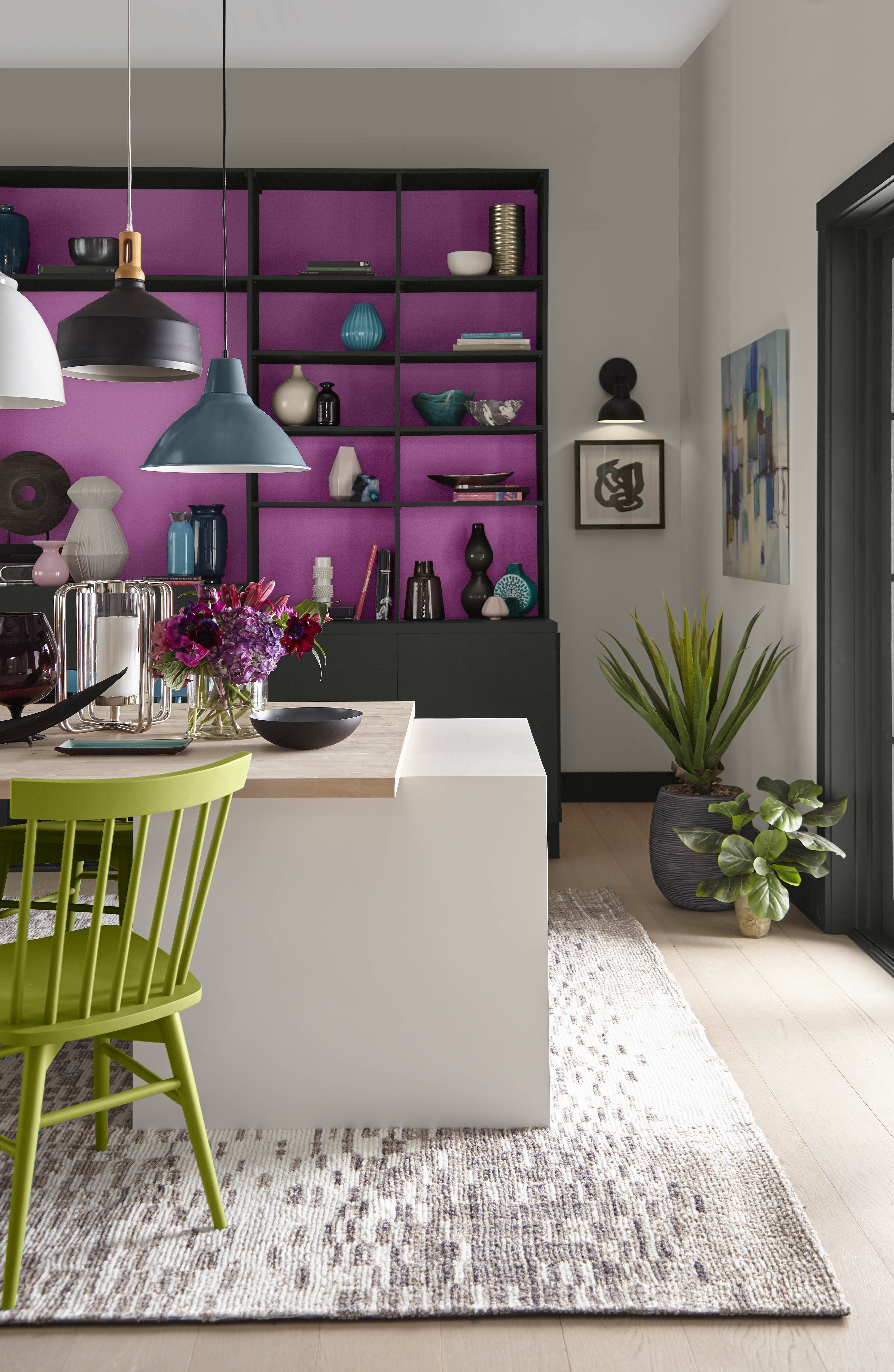 A closeup of shelves and chairs in magenta and light green accents