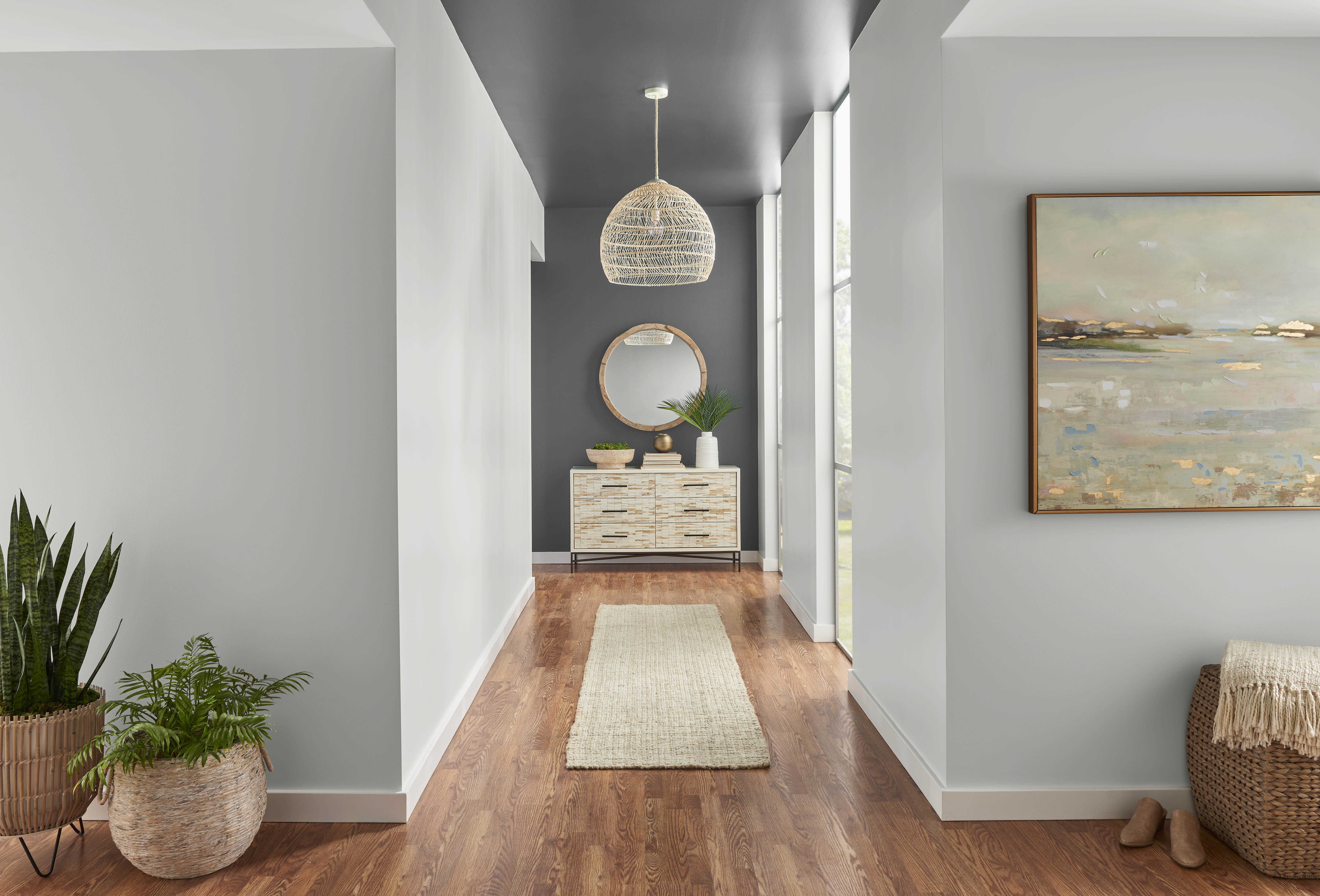 A modern hallway with walls in the colour Classic Silver and a darker grey accent wall in the colour Graphic Charcoal