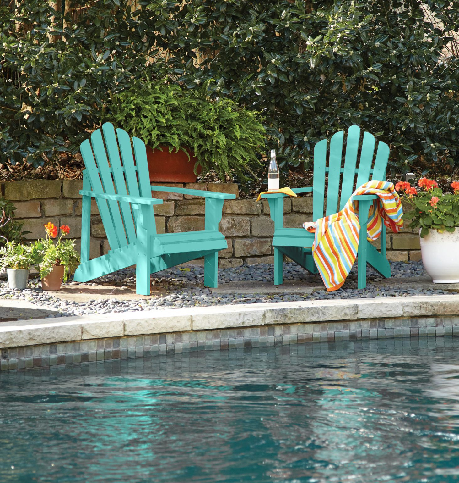 Two Muskoka chairs in the colour Hidden Sea Glass by the pool