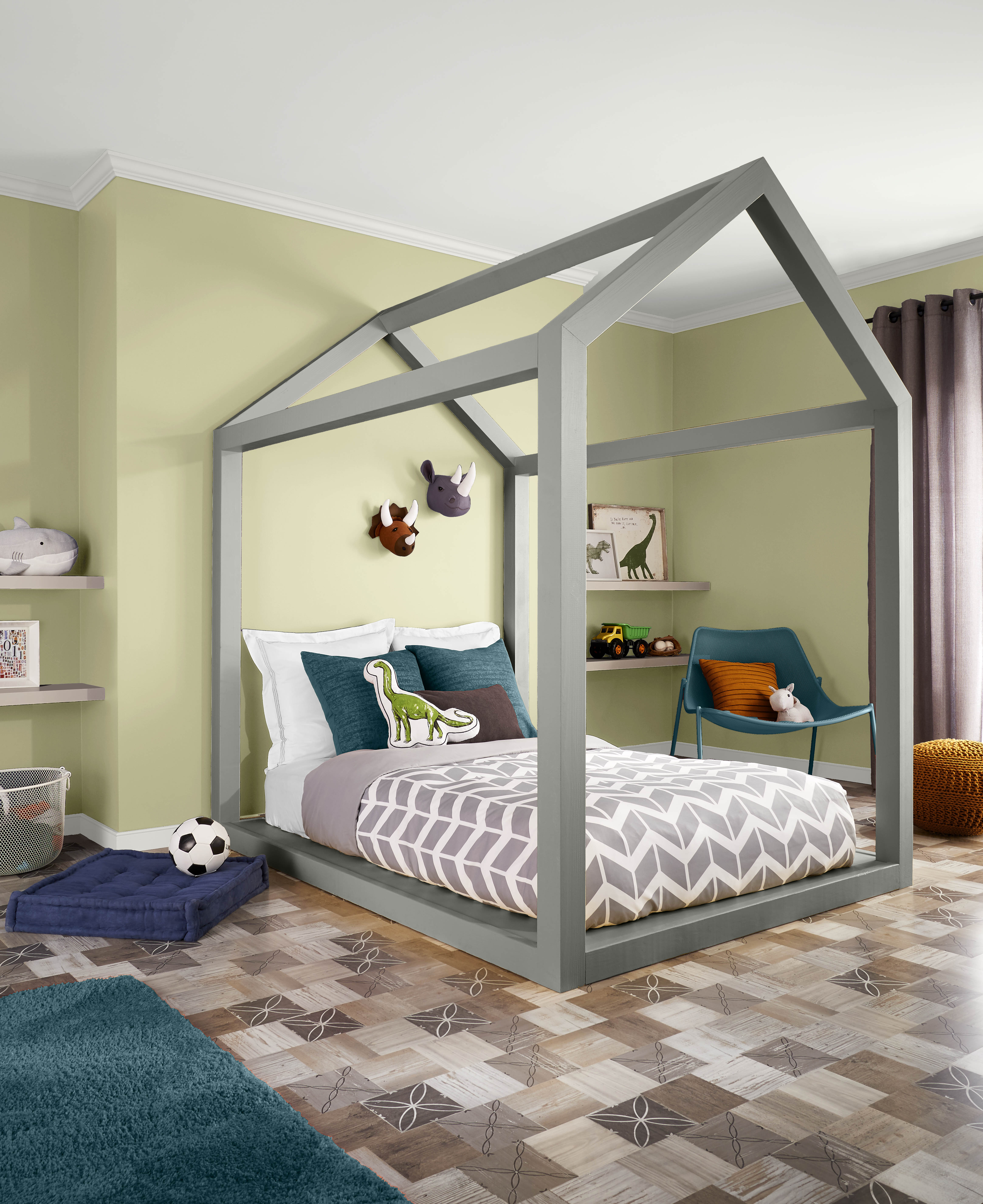 A kids room with walls in the colour Hybrid, styled with a playful bedframe and pops of grey, teal, and purple in the décor and furniture 