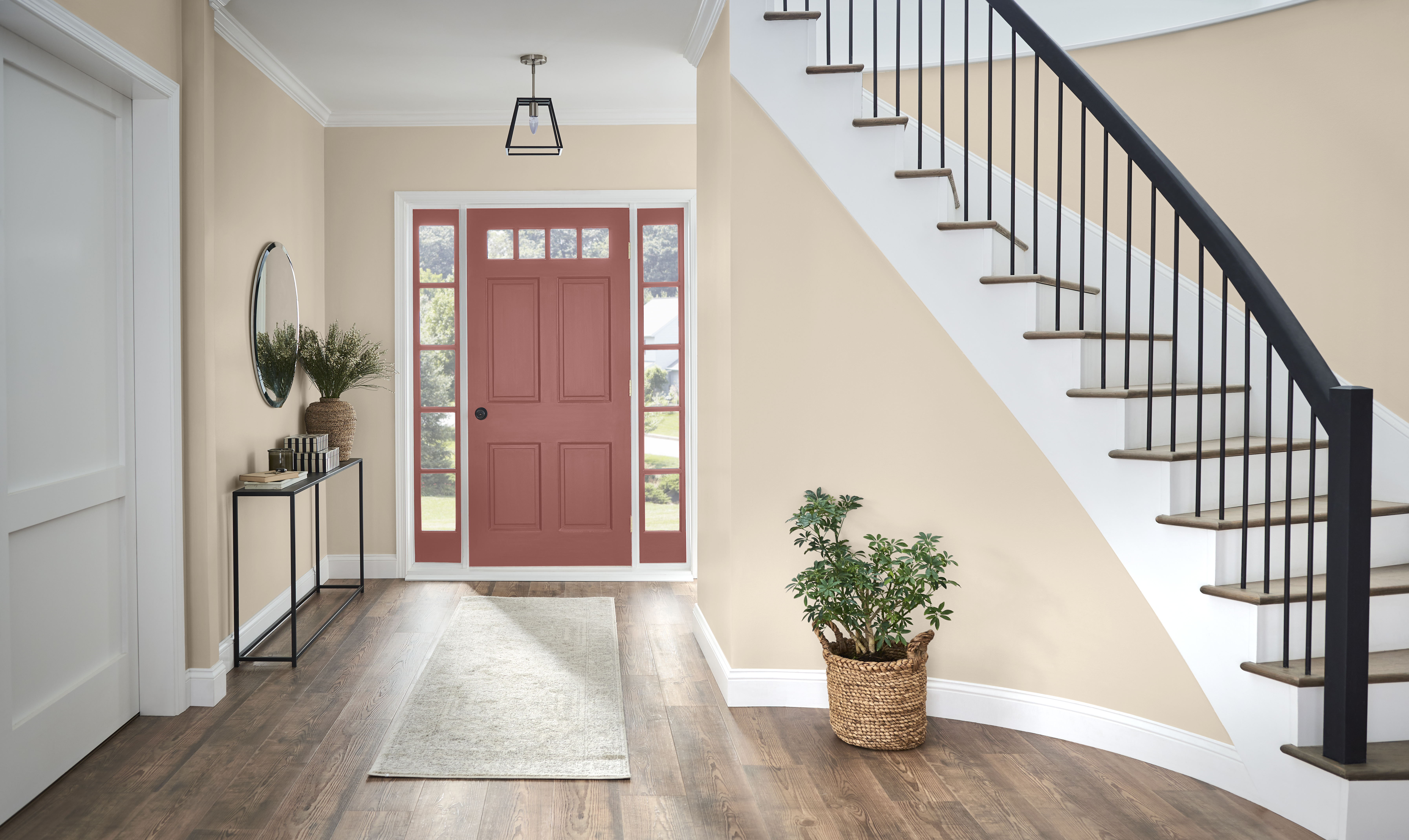 A large entryway with walls in the colour Spanish Sand and a door with windows in the colour Vermilion 